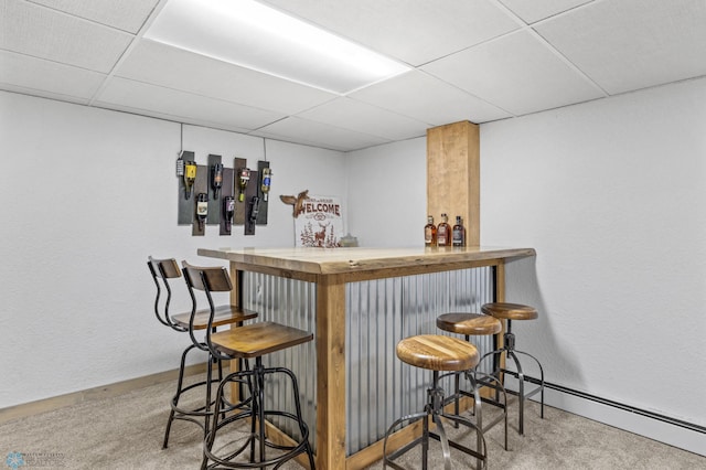 3105 Edgewood Dr N, Fargo, ND 58102 - indoor dry bar featuring a paneled ceiling, carpet, baseboards, and a baseboard radiator