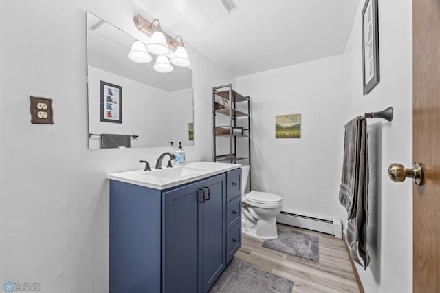 3105 Edgewood Dr N, Fargo, ND 58102 - bathroom featuring a baseboard radiator, wood finished floors, vanity, and toilet
