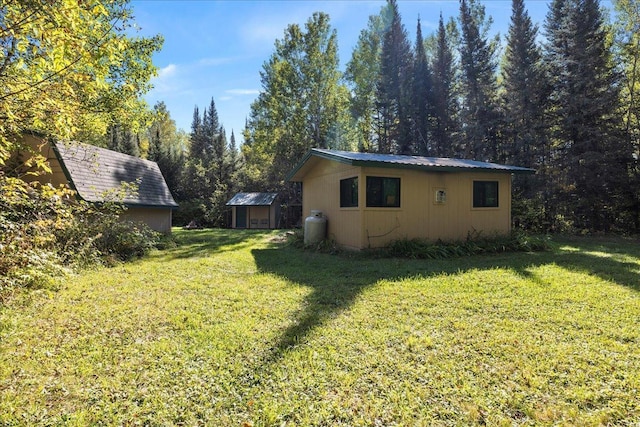 10397 Johnson Rd, Orr, MN 55771 - view of green lawn with a shed and an outbuilding