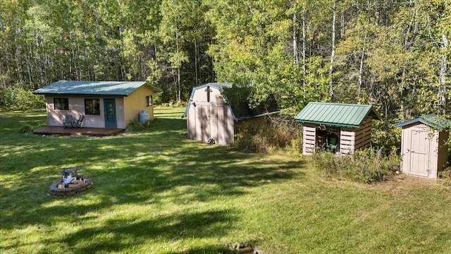 10397 Johnson Rd, Orr, MN 55771 - view of green lawn with a shed, an outbuilding, and a view of trees