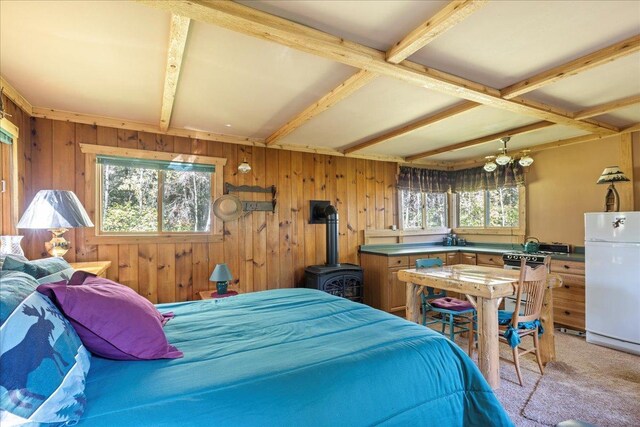 10397 Johnson Rd, Orr, MN 55771 - bedroom featuring freestanding refrigerator, wooden walls, light colored carpet, and beamed ceiling
