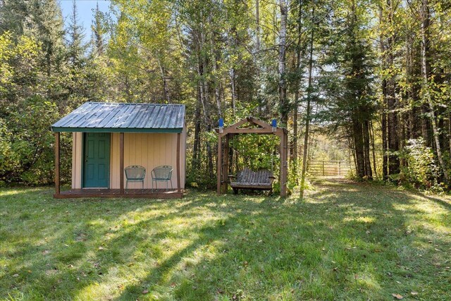 10397 Johnson Rd, Orr, MN 55771 - view of yard featuring a storage unit, an outdoor structure, and a wooded view