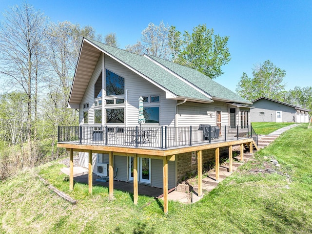 3818 Erickson Rd, Barnum, MN 55707 - rear view of property with a deck, a shingled roof, a yard, and ac unit