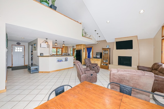 3818 Erickson Rd, Barnum, MN 55707 - dining space featuring light tile patterned floors, baseboards, a fireplace with raised hearth, high vaulted ceiling, and recessed lighting