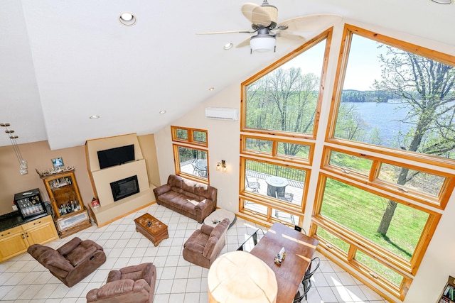 3818 Erickson Rd, Barnum, MN 55707 - living area featuring light tile patterned floors, a wall unit AC, a glass covered fireplace, a ceiling fan, and high vaulted ceiling