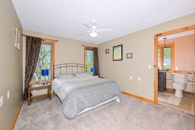3818 Erickson Rd, Barnum, MN 55707 - carpeted bedroom featuring baseboards, ensuite bath, and ceiling fan