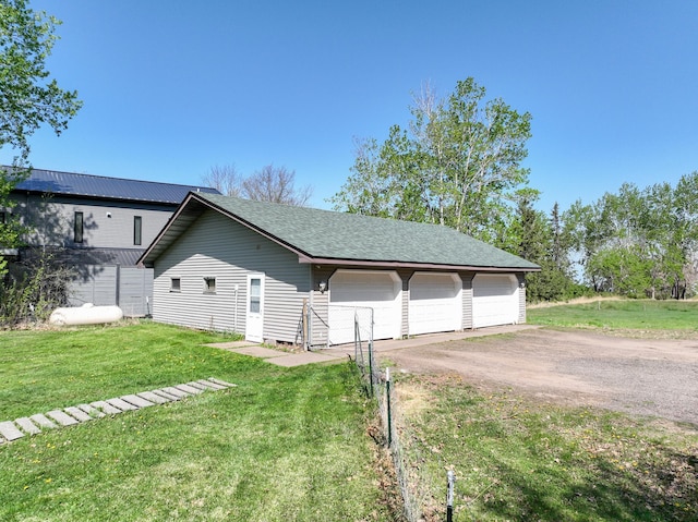 3818 Erickson Rd, Barnum, MN 55707 - view of property exterior with a garage, a yard, an outdoor structure, and a shingled roof
