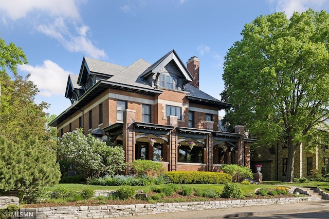 46 Crocus Pl, Saint Paul, MN 55102 - view of front facade with brick siding and a chimney