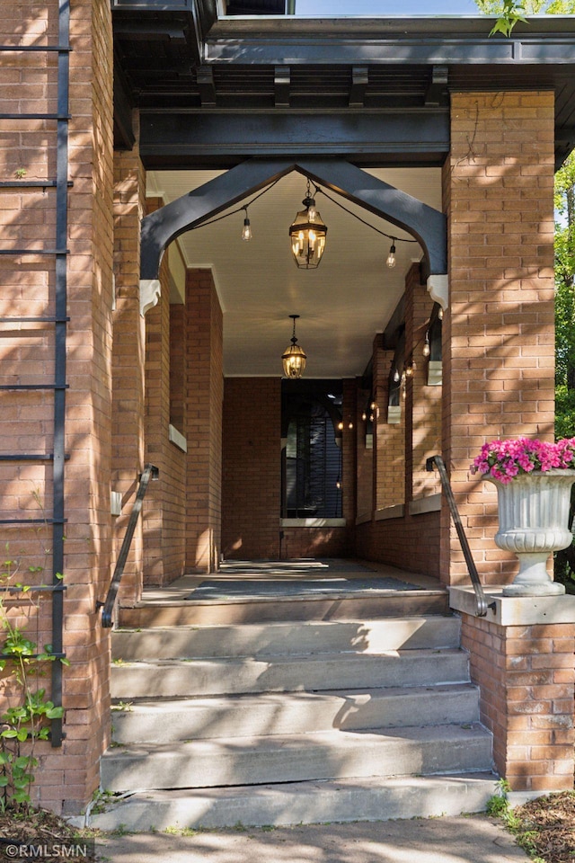 46 Crocus Pl, Saint Paul, MN 55102 - doorway to property featuring covered porch and brick siding