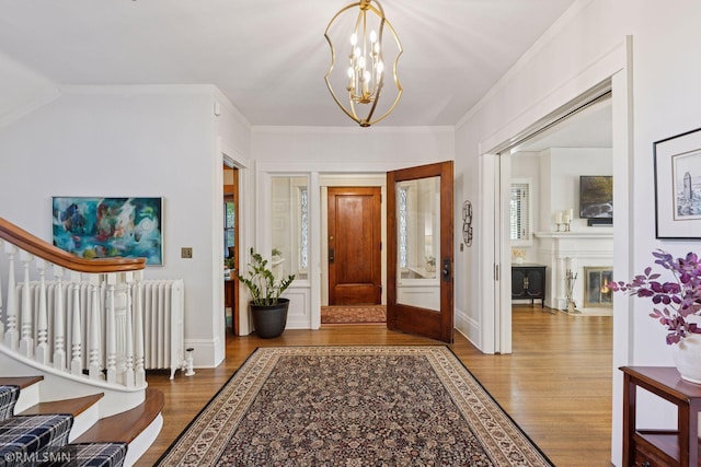 46 Crocus Pl, Saint Paul, MN 55102 - entryway featuring wood finished floors, stairs, radiator heating unit, a chandelier, and crown molding