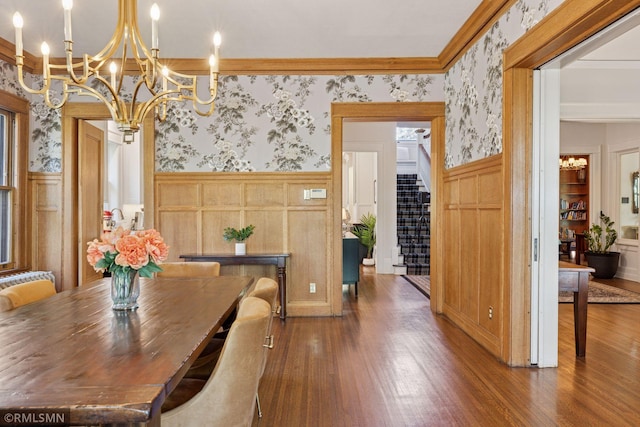 46 Crocus Pl, Saint Paul, MN 55102 - dining room featuring wallpapered walls, a chandelier, wood finished floors, a wainscoted wall, and a decorative wall