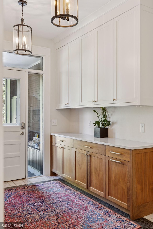 46 Crocus Pl, Saint Paul, MN 55102 - kitchen featuring light countertops, pendant lighting, brown cabinets, and a chandelier