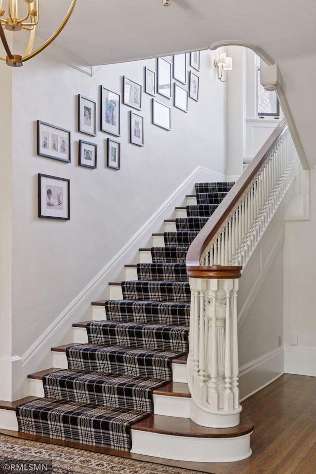 46 Crocus Pl, Saint Paul, MN 55102 - stairway with a chandelier, wood finished floors, arched walkways, and baseboards