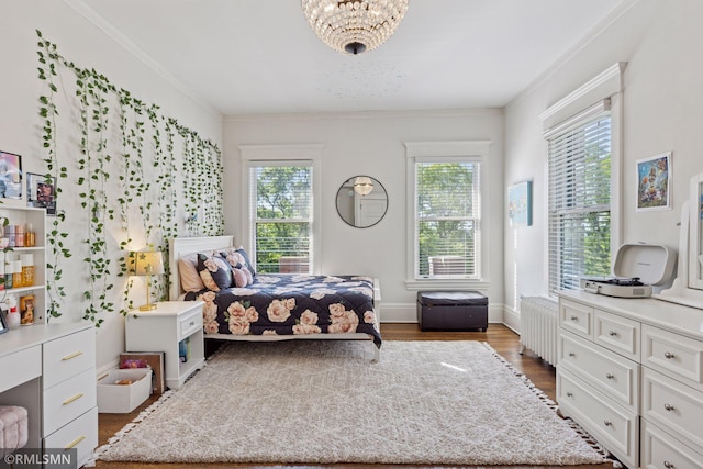 46 Crocus Pl, Saint Paul, MN 55102 - bedroom with wood finished floors, a chandelier, and ornamental molding