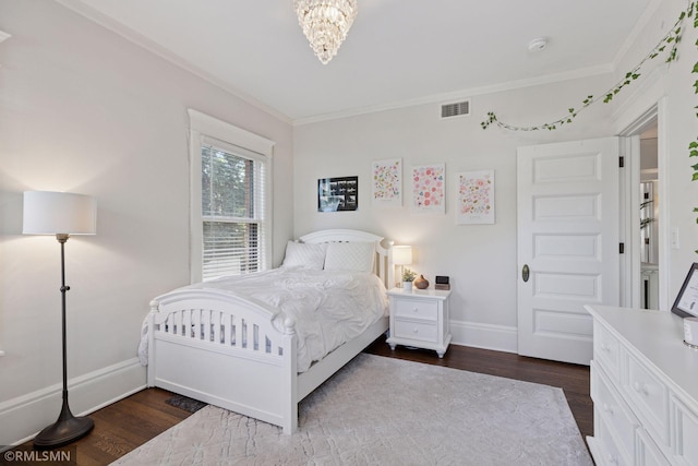 46 Crocus Pl, Saint Paul, MN 55102 - bedroom with baseboards, dark wood finished floors, crown molding, and a chandelier