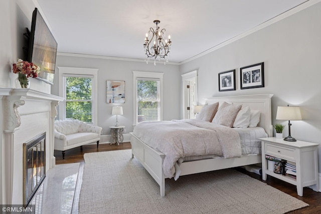 46 Crocus Pl, Saint Paul, MN 55102 - bedroom featuring a chandelier, ornamental molding, dark wood-style floors, a fireplace with flush hearth, and baseboards