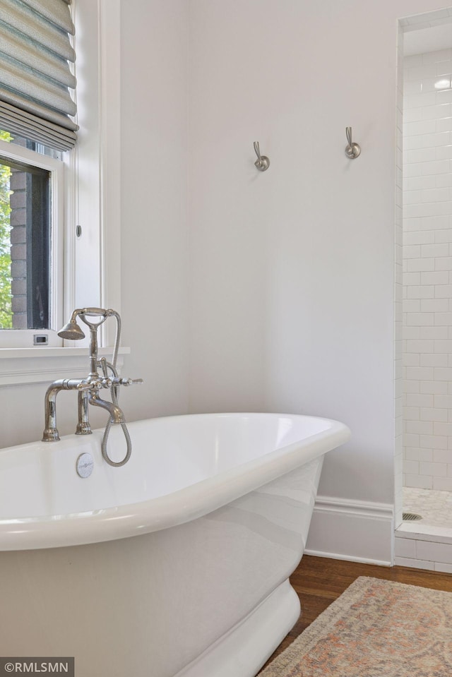 46 Crocus Pl, Saint Paul, MN 55102 - full bath featuring wood finished floors, a tile shower, a soaking tub, and baseboards