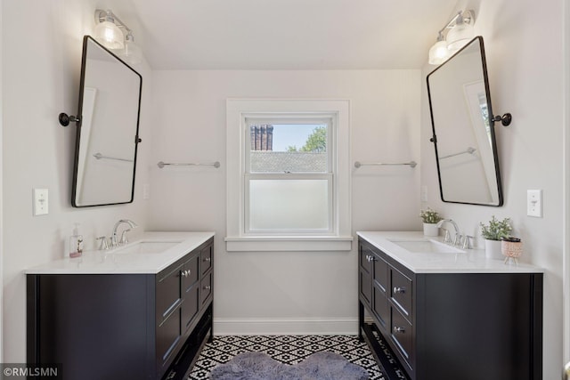 46 Crocus Pl, Saint Paul, MN 55102 - full bath with baseboards, two vanities, and tile patterned floors