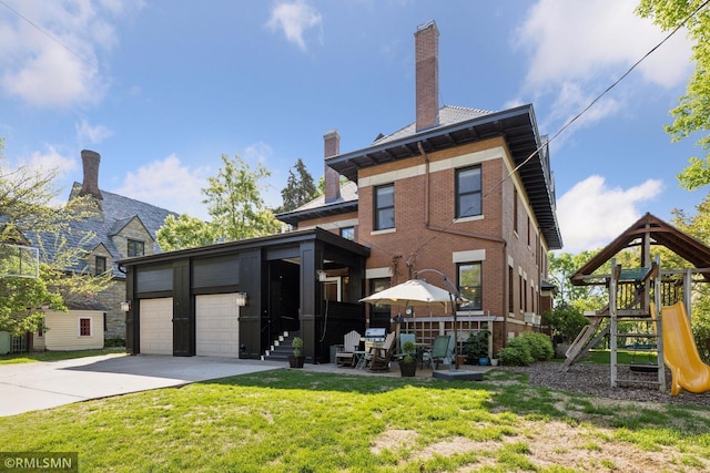 46 Crocus Pl, Saint Paul, MN 55102 - back of house with a yard, a garage, concrete driveway, and a chimney