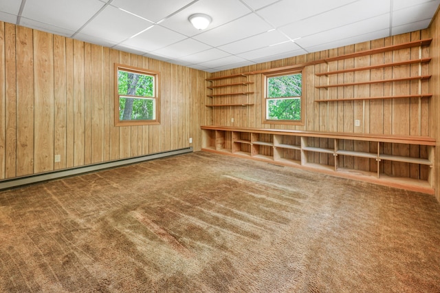 18587 Dover Rd, Clearwater, MN 55320 - carpeted spare room featuring wooden walls, plenty of natural light, a baseboard radiator, and a paneled ceiling