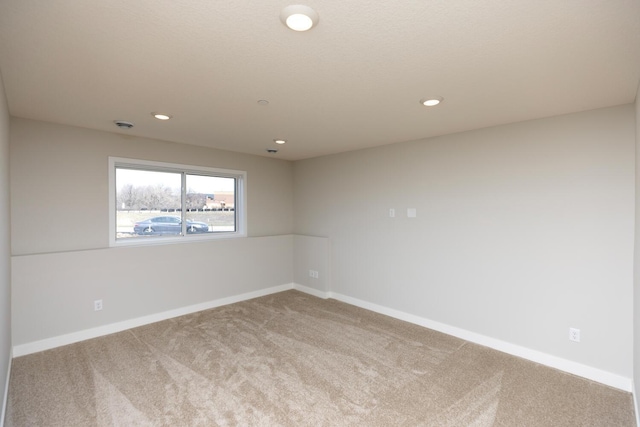 unfurnished room featuring carpet floors, baseboards, and recessed lighting