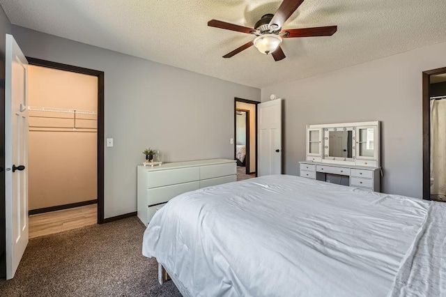 10034 191st Ave NW, Elk River, MN 55330 - bedroom with carpet flooring, a textured ceiling, ceiling fan, and a walk in closet