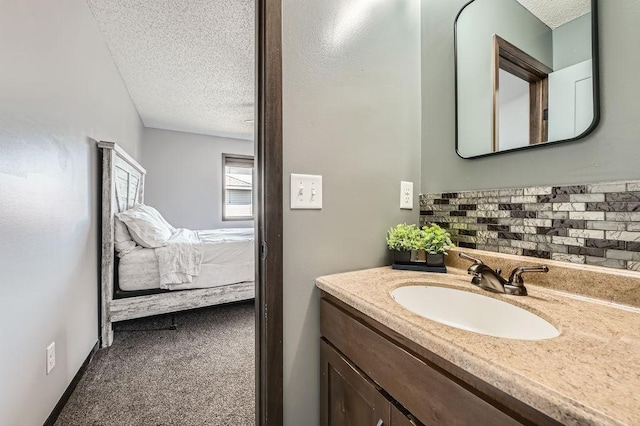 10034 191st Ave NW, Elk River, MN 55330 - bathroom with a textured ceiling, vanity, and tasteful backsplash