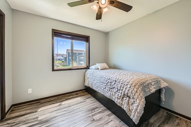 10034 191st Ave NW, Elk River, MN 55330 - bedroom with wood finished floors and a ceiling fan