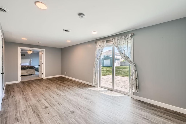 10034 191st Ave NW, Elk River, MN 55330 - unfurnished living room featuring wood finished floors, baseboards, a ceiling fan, and recessed lighting