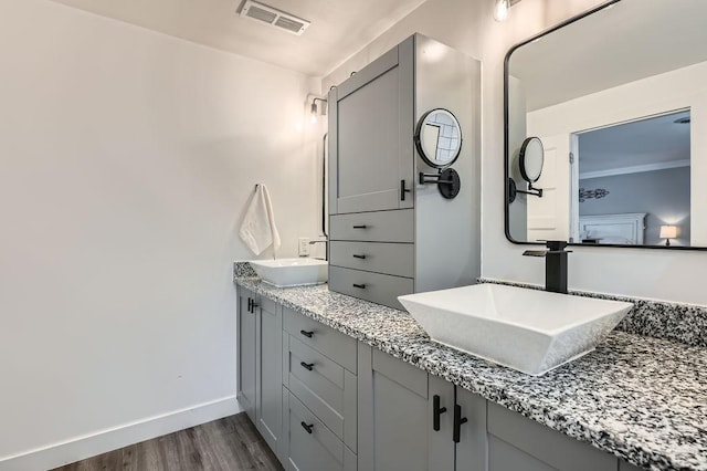 10034 191st Ave NW, Elk River, MN 55330 - full bathroom with wood finished floors, double vanity, and baseboards