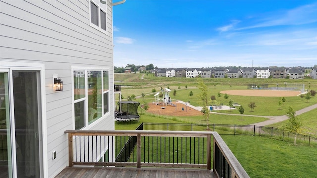 10082 Arrowwood Trl, Woodbury, MN 55129 - wooden terrace featuring a trampoline, a fenced backyard, and a residential view