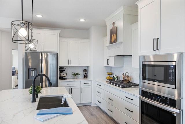 10082 Arrowwood Trl, Woodbury, MN 55129 - kitchen with stainless steel appliances, white cabinets, decorative backsplash, pendant lighting, and recessed lighting