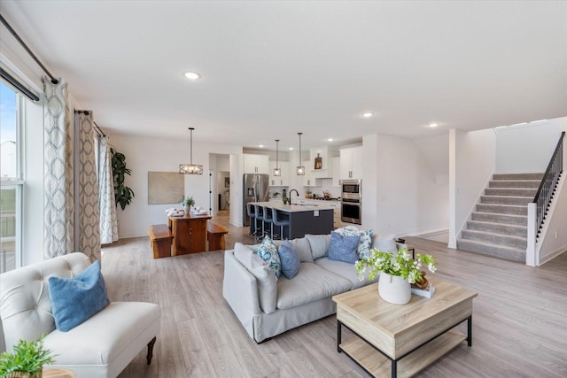 10082 Arrowwood Trl, Woodbury, MN 55129 - living room with light wood-style flooring, stairs, and recessed lighting