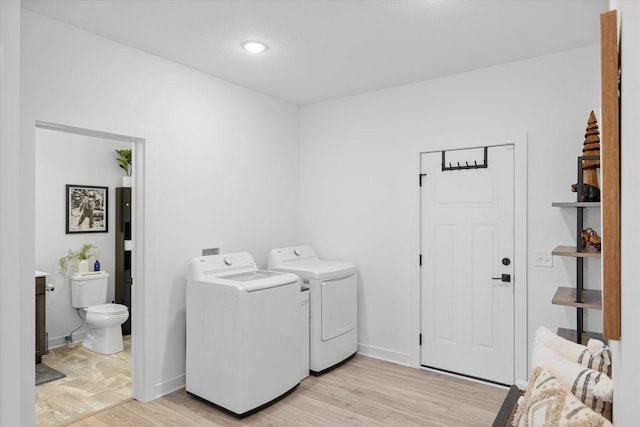 10082 Arrowwood Trl, Woodbury, MN 55129 - washroom featuring washer and clothes dryer and light wood-type flooring