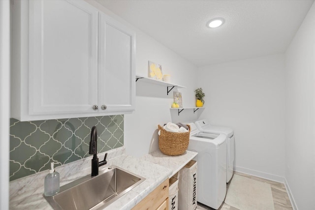 10082 Arrowwood Trl, Woodbury, MN 55129 - laundry area with cabinet space, washer and clothes dryer, and a textured ceiling