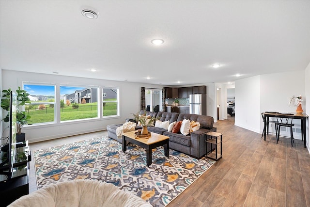 10082 Arrowwood Trl, Woodbury, MN 55129 - living room with light wood-style flooring and recessed lighting