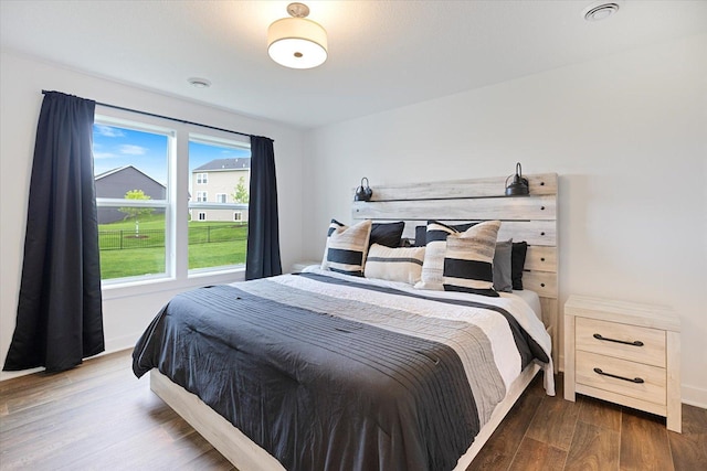 10082 Arrowwood Trl, Woodbury, MN 55129 - bedroom with dark wood finished floors and baseboards
