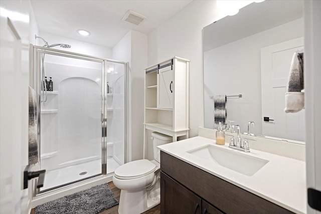 10082 Arrowwood Trl, Woodbury, MN 55129 - bathroom with a stall shower, vanity, and wood finished floors