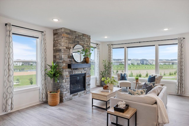 10082 Arrowwood Trl, Woodbury, MN 55129 - living room featuring a fireplace, wood finished floors, and recessed lighting