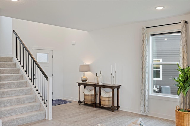 10082 Arrowwood Trl, Woodbury, MN 55129 - stairs featuring wood finished floors and baseboards