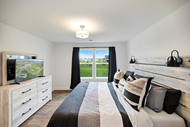10082 Arrowwood Trl, Woodbury, MN 55129 - bedroom with dark wood-style floors and baseboards
