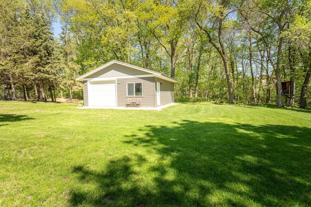 2510 Conifer Ave, Alexandria, MN 56308 - view of green lawn featuring a garage and an outbuilding