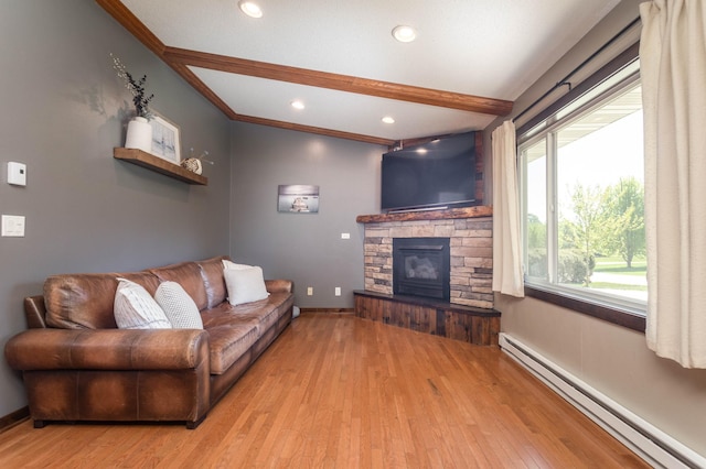 2510 Conifer Ave, Alexandria, MN 56308 - living area featuring a baseboard radiator, a stone fireplace, wood finished floors, baseboards, and recessed lighting