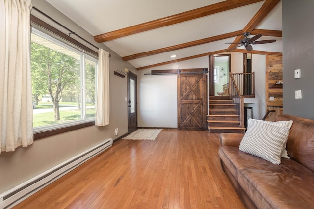 2510 Conifer Ave, Alexandria, MN 56308 - living area featuring a baseboard radiator, a barn door, light wood-style flooring, and stairway