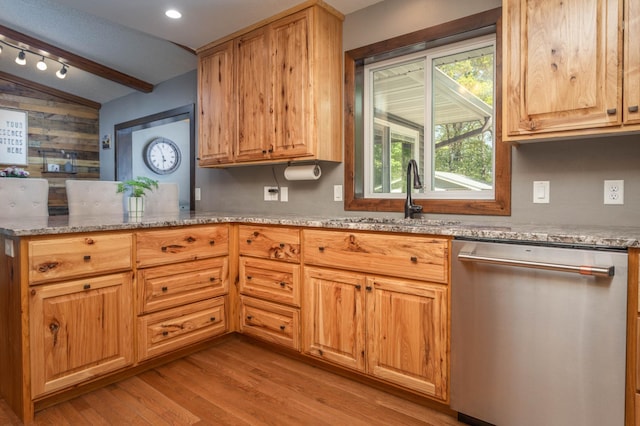 2510 Conifer Ave, Alexandria, MN 56308 - kitchen with stainless steel dishwasher, a sink, light wood finished floors, light stone countertops, and a peninsula