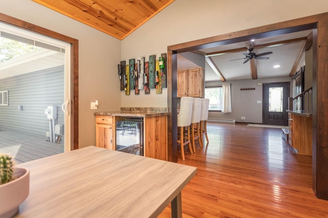2510 Conifer Ave, Alexandria, MN 56308 - kitchen featuring beverage cooler, vaulted ceiling, wood finished floors, a ceiling fan, and baseboards