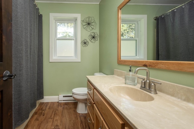 2510 Conifer Ave, Alexandria, MN 56308 - bathroom featuring baseboard heating, toilet, wood finished floors, baseboards, and vanity