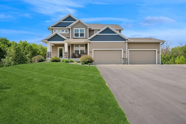 24000 Helium Ct, Forest Lake, MN 55025 - craftsman inspired home featuring a porch, asphalt driveway, a front yard, an attached garage, and stone siding