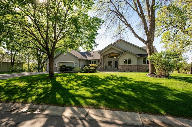 14573 Krypton St NW, Ramsey, MN 55303 - view of front of property with a garage, brick siding, a front yard, and driveway