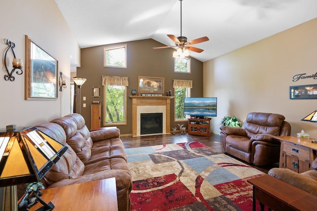 14573 Krypton St NW, Ramsey, MN 55303 - living area with a ceiling fan, a tiled fireplace, wood finished floors, high vaulted ceiling, and baseboards